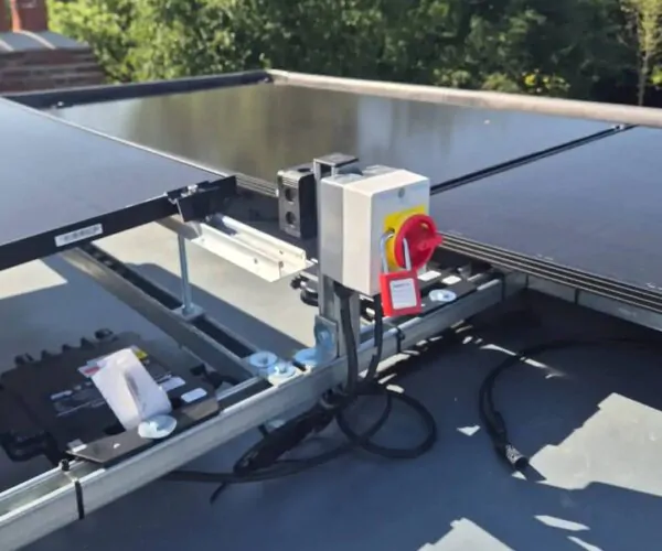 Close-up view of a solar inverter and isolator switch connected to a rooftop solar PV system