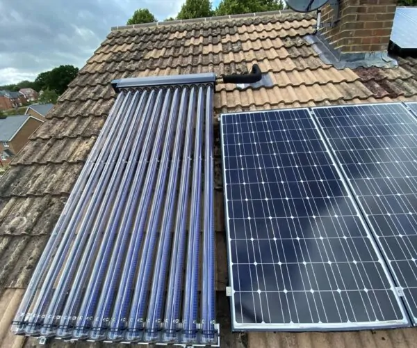 Combined solar thermal tubes and photovoltaic (PV) panels installed on a pitched roof in Sussex