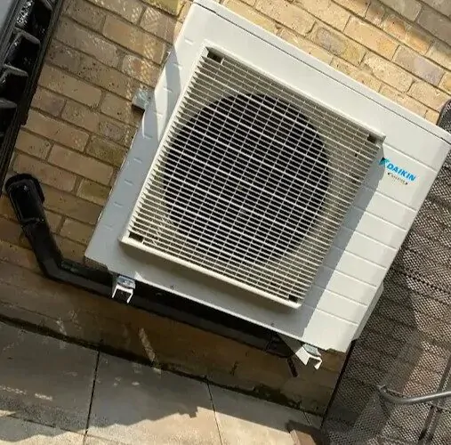 Daikin outdoor air conditioning unit fixed to brick wall